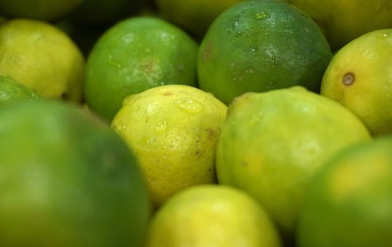 green and yellow lime fruits in close up photo